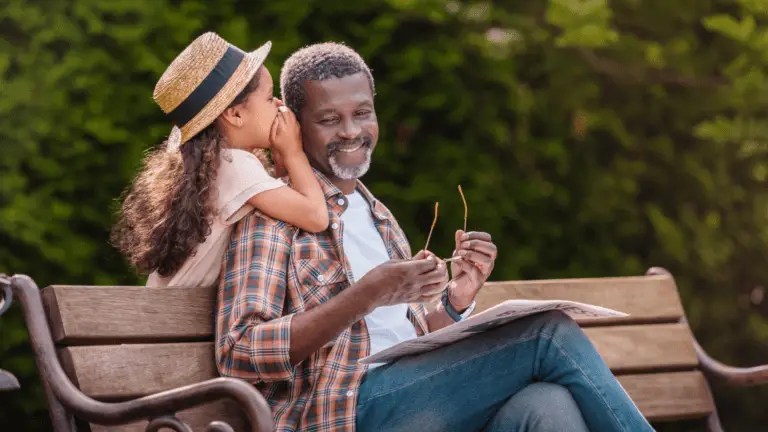 grandfather and grandaughter at the park, protected with final expense insurance