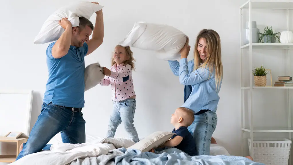 mom and dad playing with two kids just got term life insurance