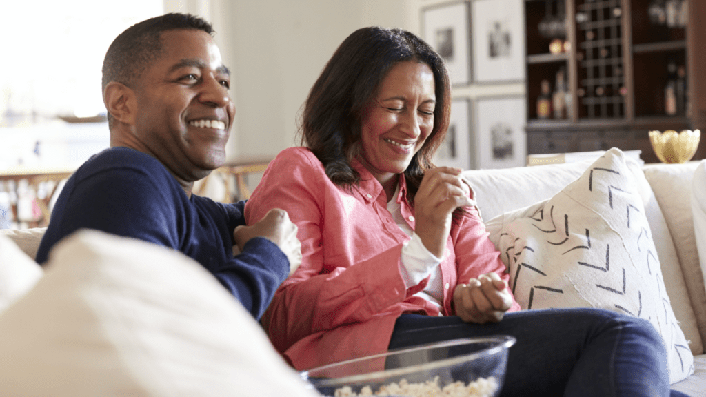 couple sitting on couch shopping online for life insurance