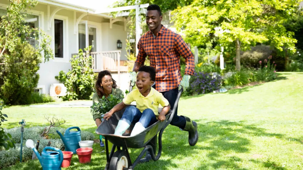 dad and two kids playing in yard, protected with mortgage insurance