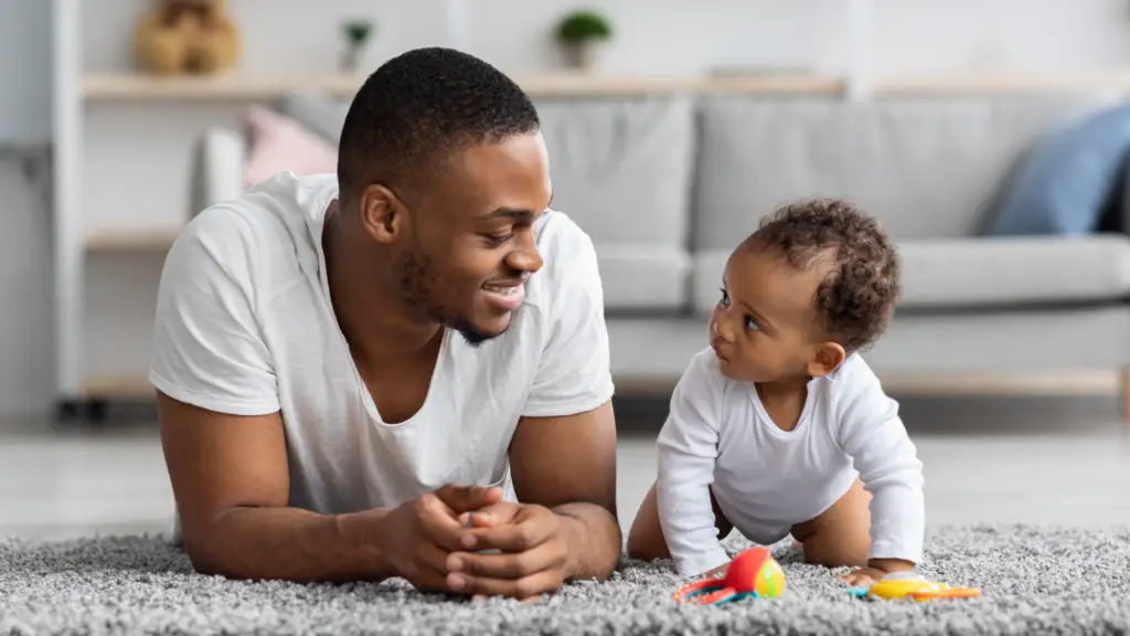 man on floor with baby