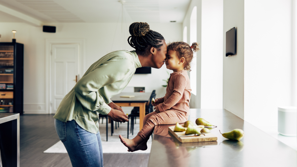 mom and young daughter in kitchen with a snack sitting on counter