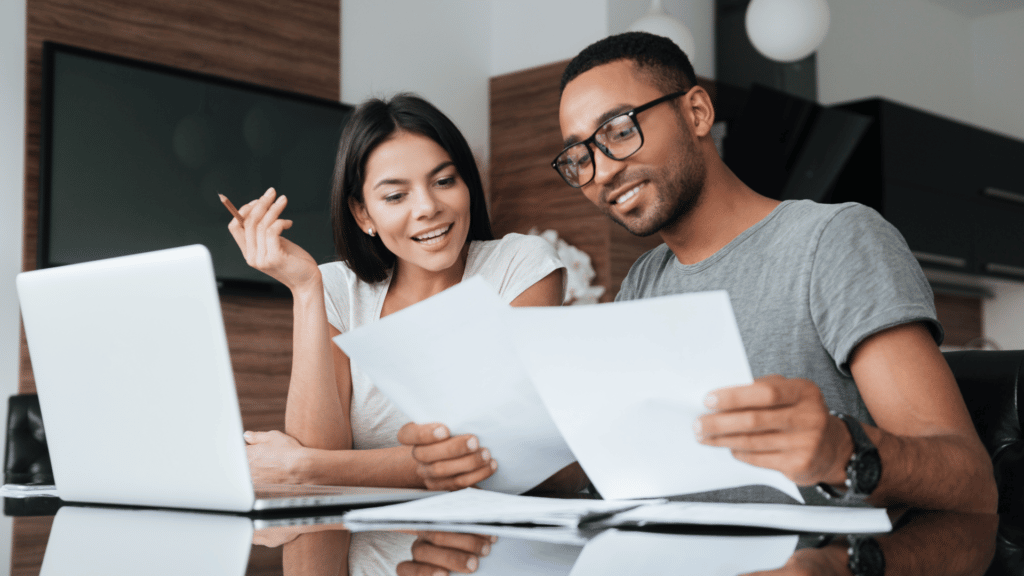 man and woman planning budget with Quility Debt Free Life spending planner
