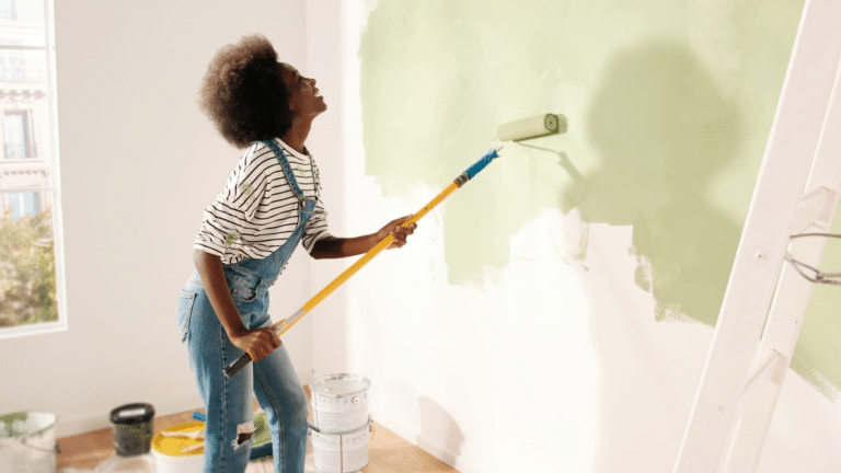 woman painting wall in new home