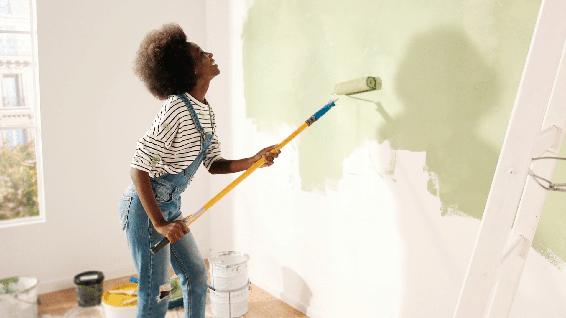 woman painting wall in new home