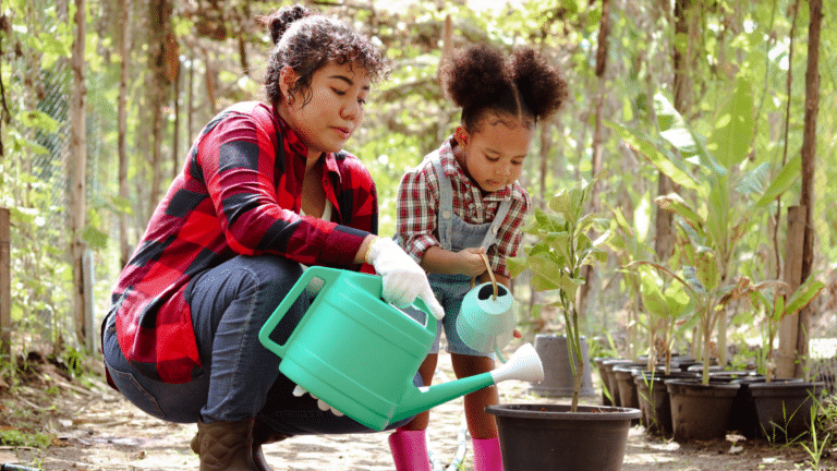 mom with daughter planting seeds in garden