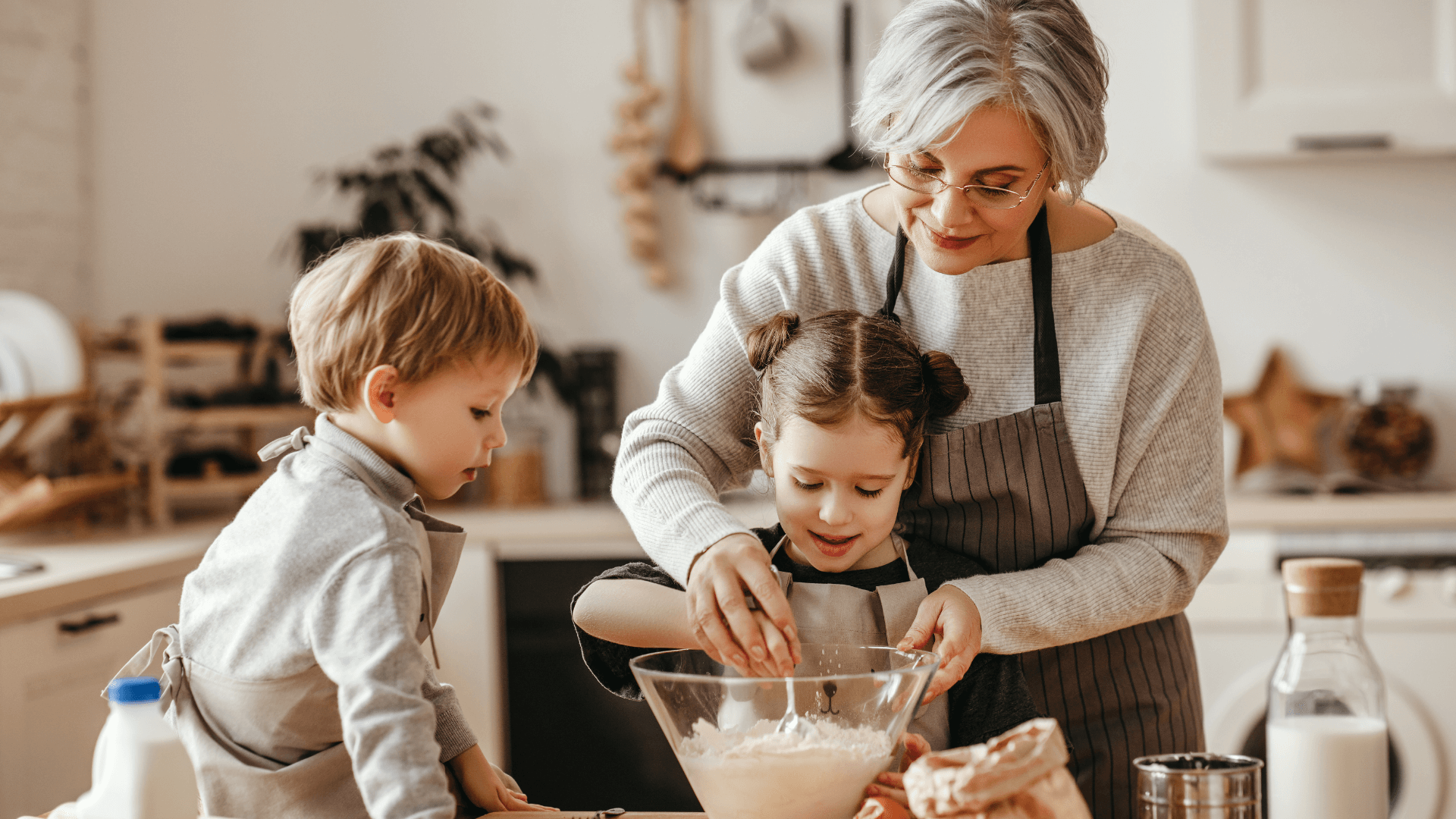 Grandma with two grandchildren baking a recipe together