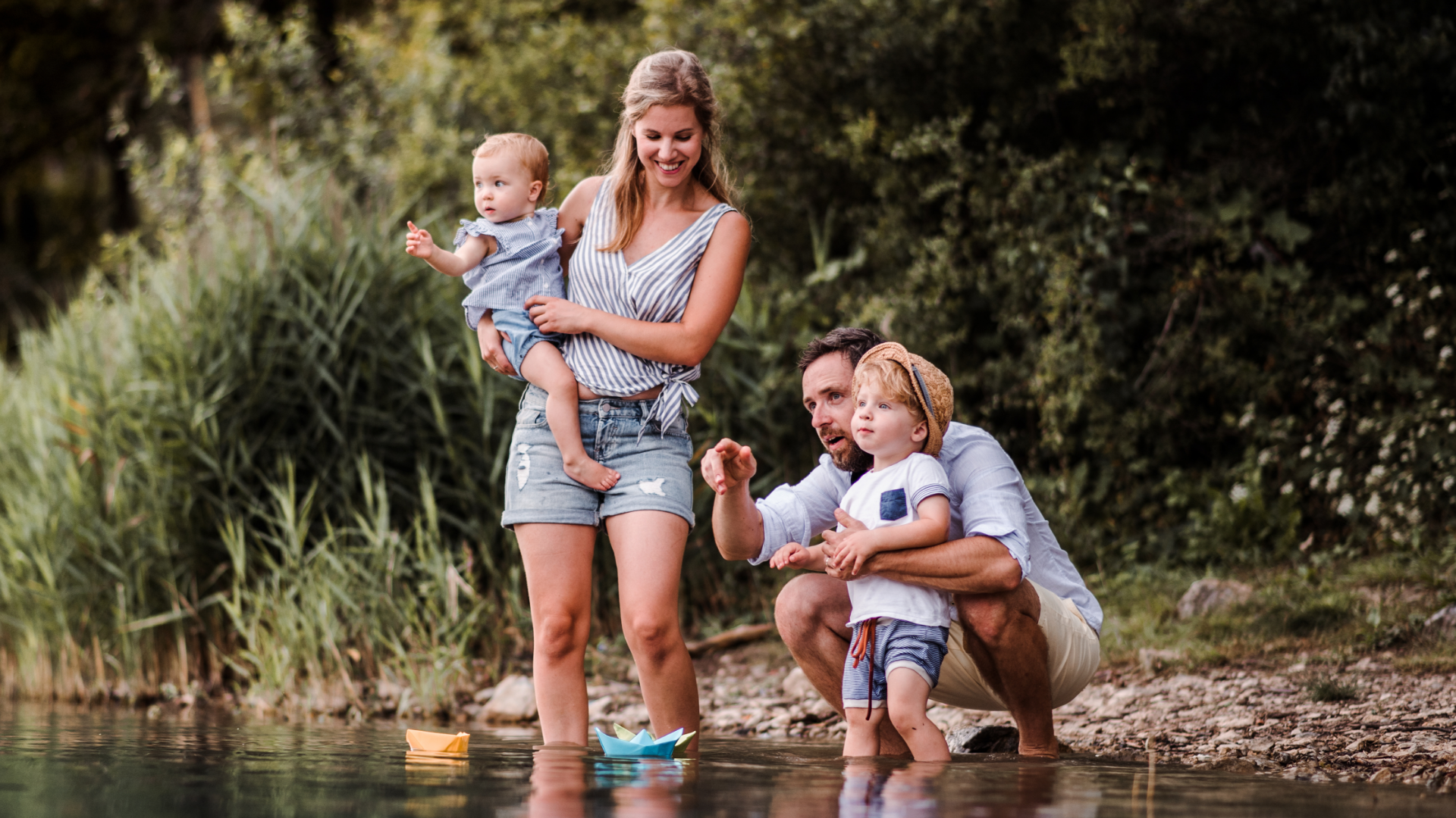 young family wading in a creek