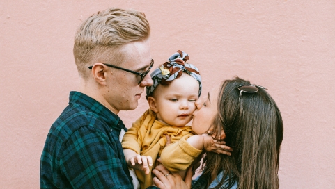 Father, Mother and daughter group hug, just qualified for term life insurance with Quility