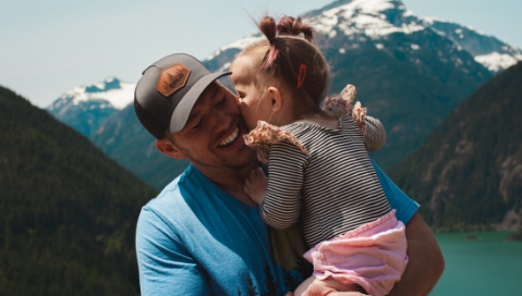 Father holding daughter, just got mortgage protection insurance online with Quility