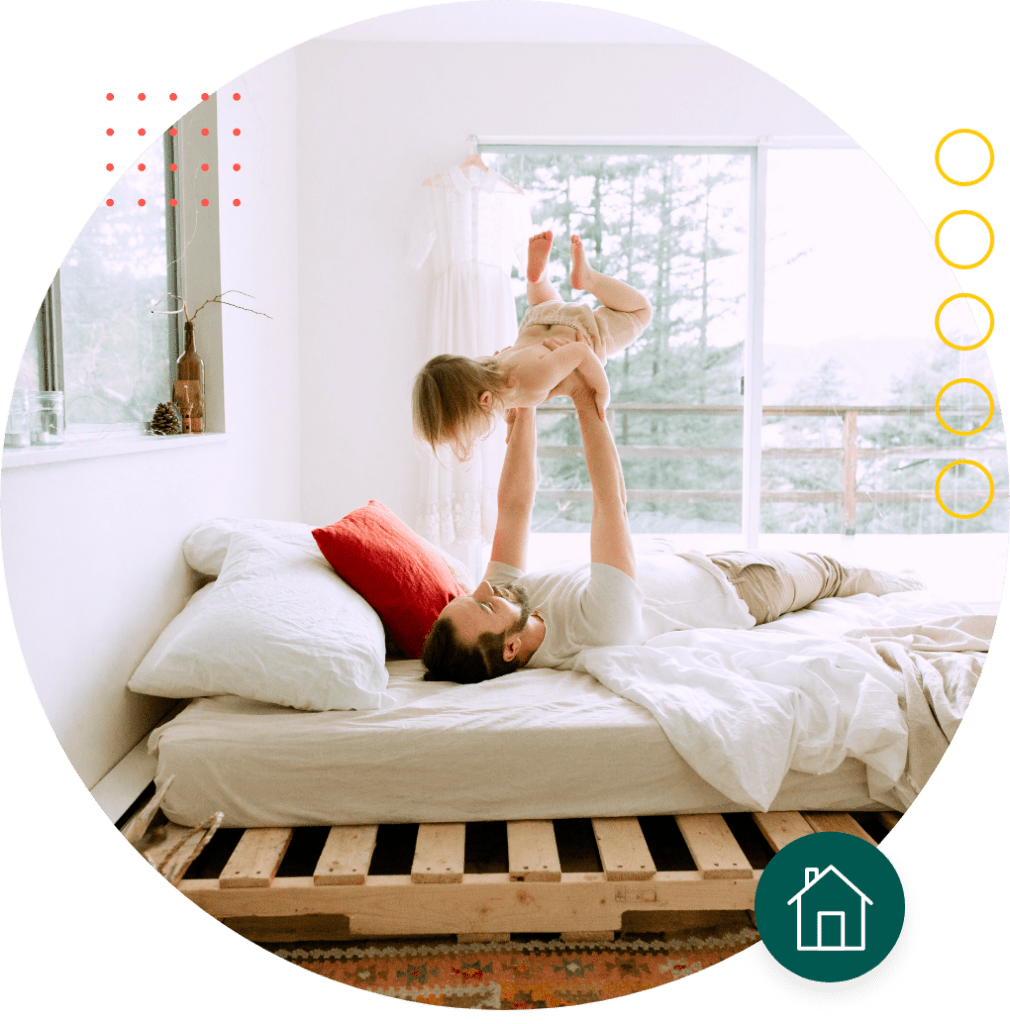 Father holding daughter up in the air, just applied online for mortgage protection insurance with Quility