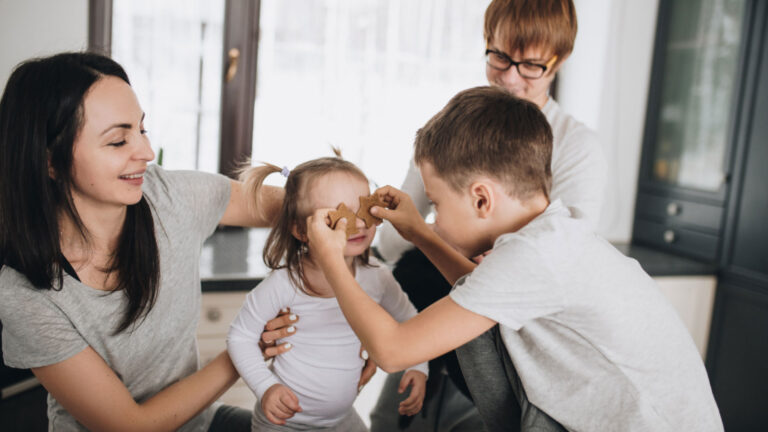 family three children and mom playing together