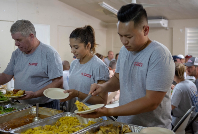 Quility staff and volunteers serve food