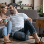 man and woman sitting on floor paying off debt with Debt Free Life