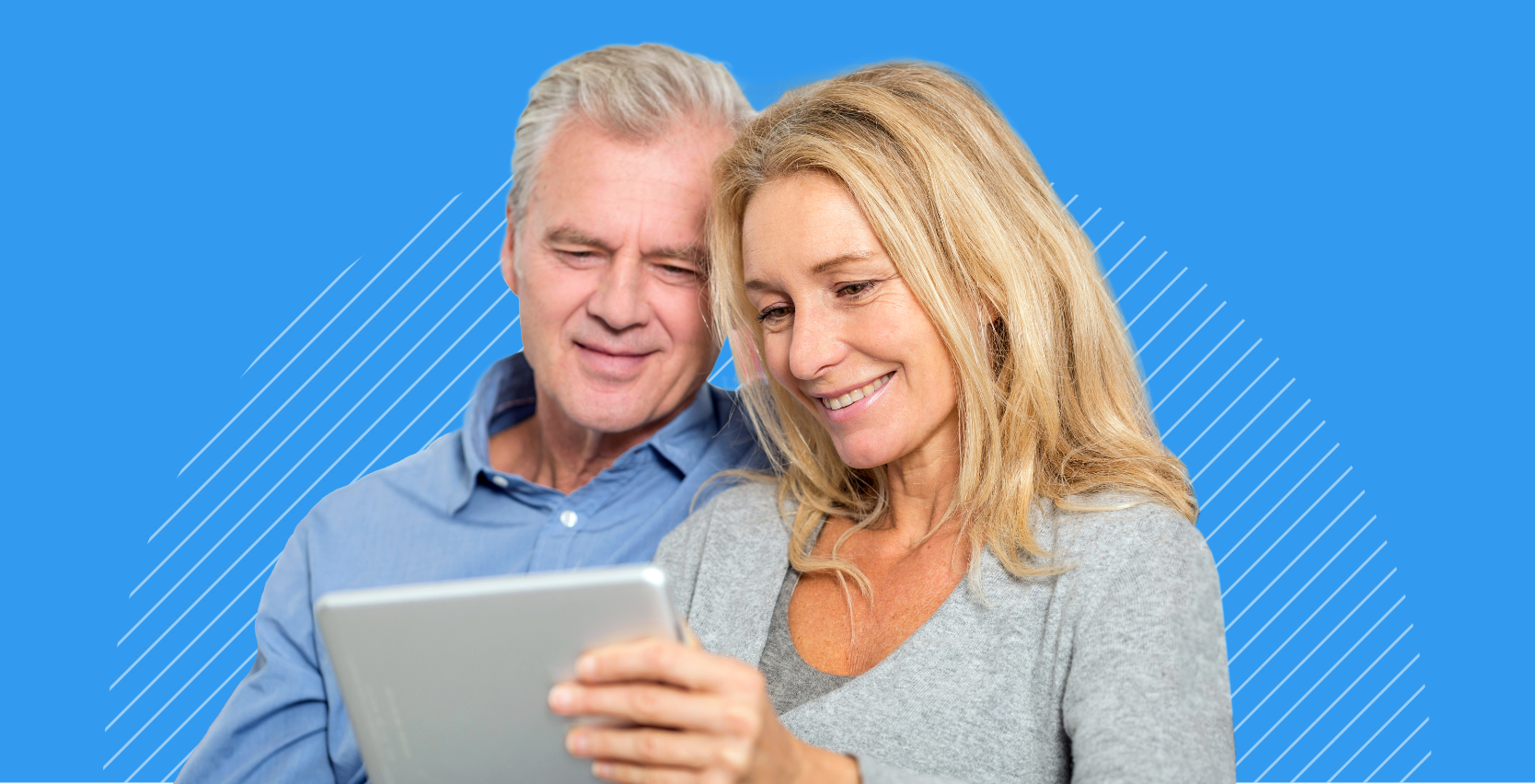Man and woman smiling and looking at annuity retirement plan on a tablet