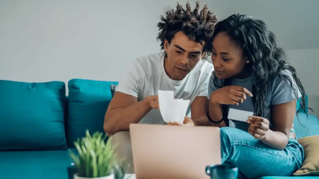 man and woman looking at bills, credit card debt